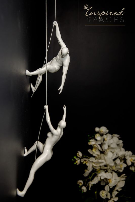 white wall climbing sculptures