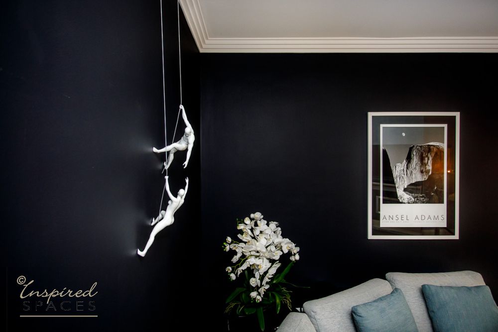 Black wall with white climbing sculpture art