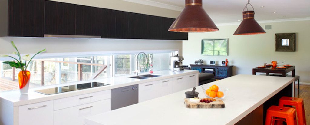 Modern kitchen which cleverly utilises a long outside window as an interesting bench top 'splash back'