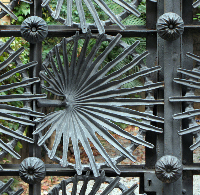 Metal gate with art nouveau decorative leaf embellishments