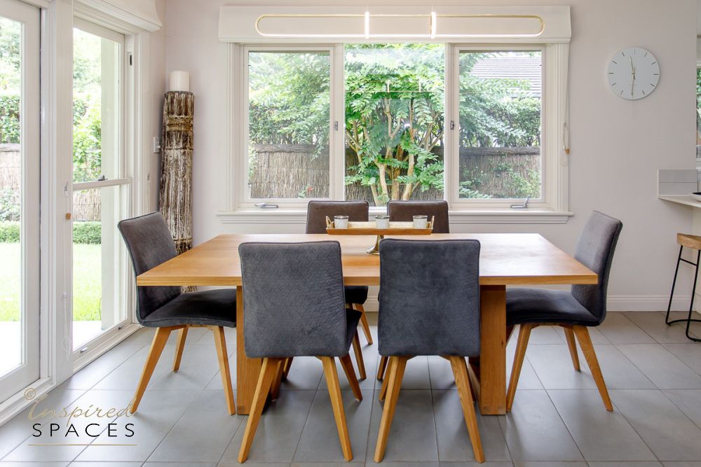 oak rectangular dining table with grey upholstered chairs